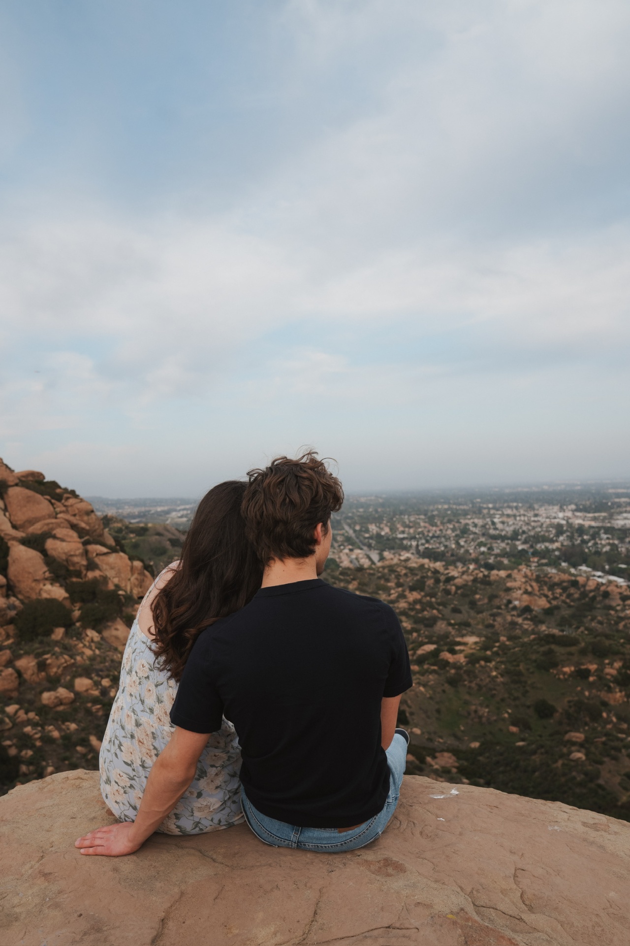 Couple seated on a boulder overlooking the valley from Stoney Point