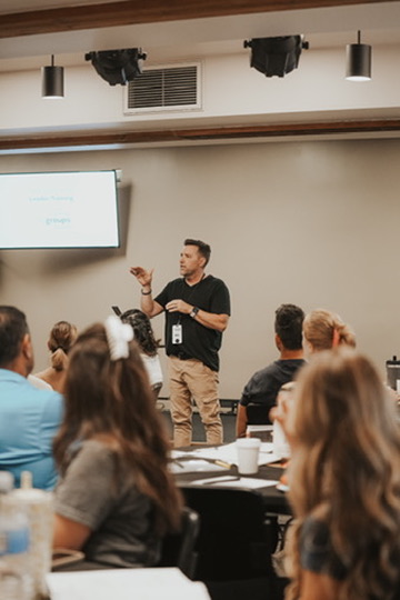 Speaker presenting to a seated audience at a workshop